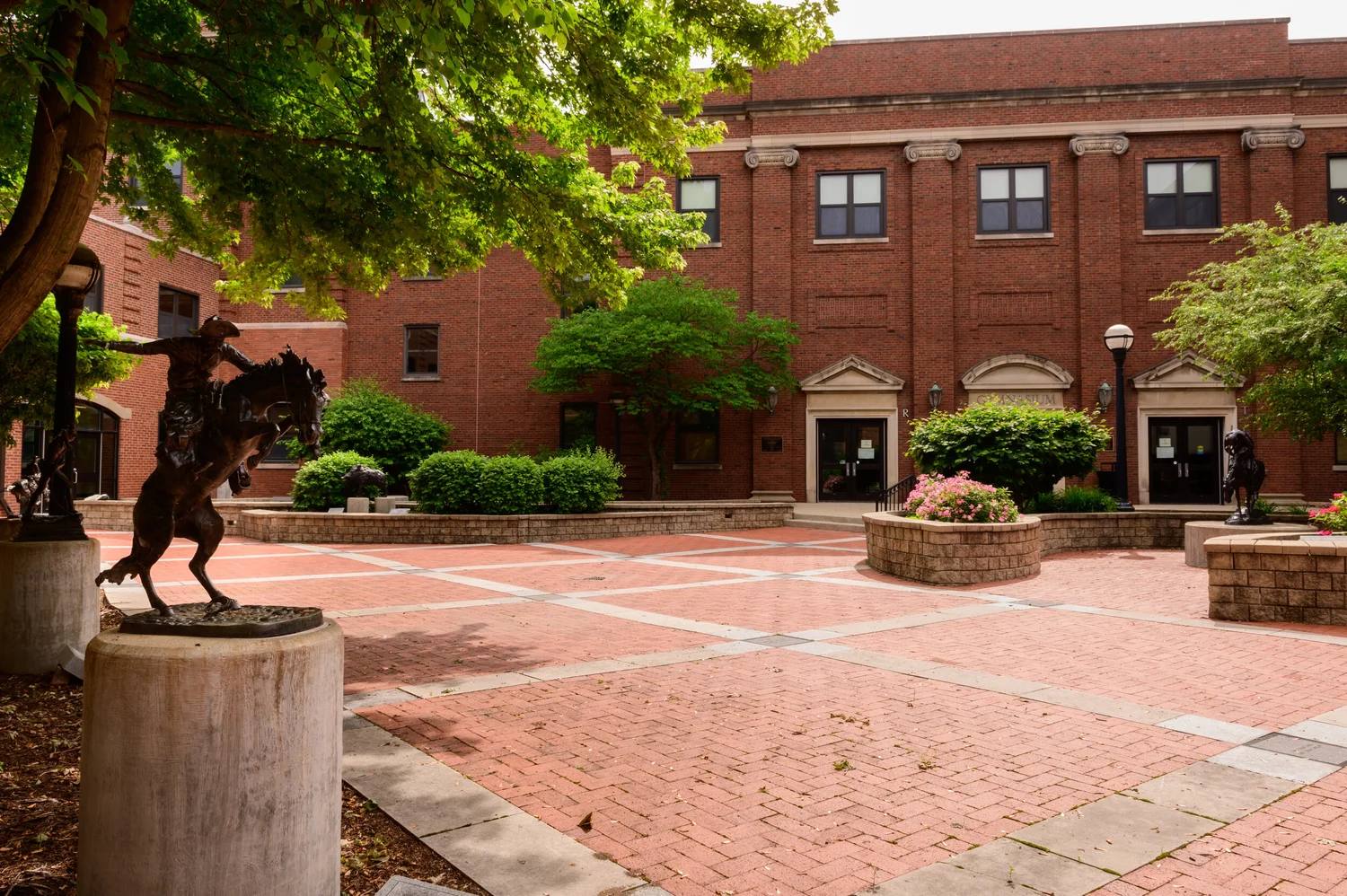 The Spangler and Scherer Courtyard: brick walkway, bronze statues and planters